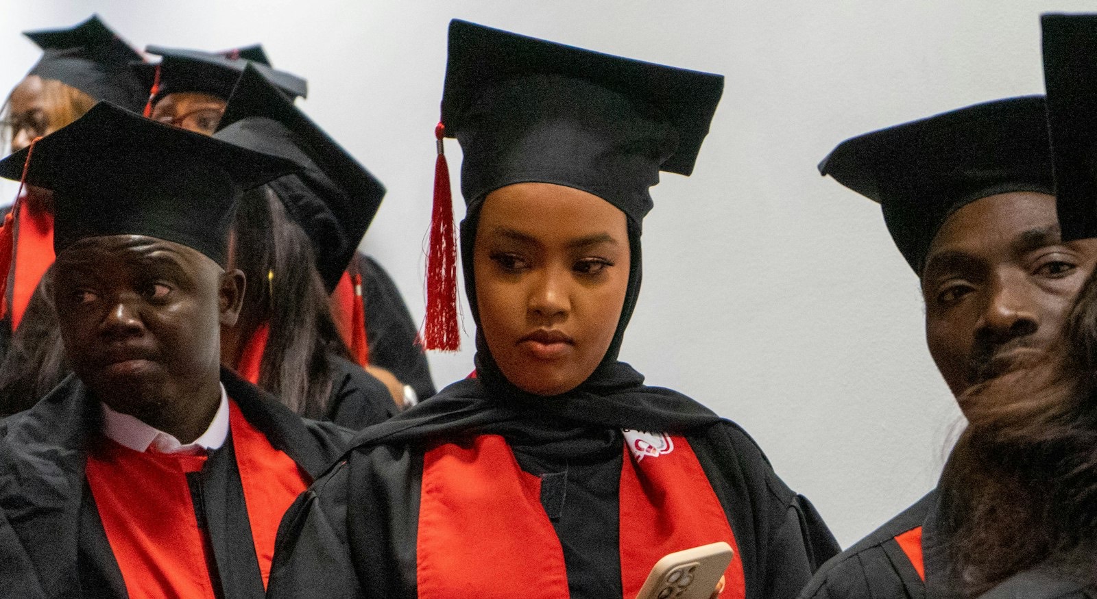 Graduates in caps and gowns at commencement.